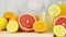 Citrus summer decoration with sliced grapefruit, lemons, oranges, lemonade in drinking glass and orange juice in jug