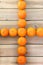 Citrus tankan cross against wooden background