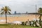 City beach in Barcelona, people relax on the sand.