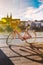 City bicycle with basket on the steering wheel of red color on the quay near the river Rhine in Switzerland against the