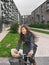 City bike Asian girl happy riding bicycle commuting outside condo apartment building street