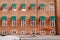 City with brick houses and cyclists driving on historical streets of Copenhagen, Denmark. One of the bicyclist