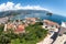 The city of Budva with the old town with fortified walls and red roofs. View from above, wide angle. Montenegro
