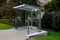 city bus stop. glass shelter with integrated wooden bench.