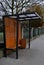city bus stop. glass shelter with integrated wooden bench