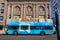 City bus stopped at a red light in front of a stunning building in Downtown Fresno, CA