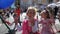 At a city festival, children ride a chain carousel