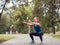 City fitness. Caucasian girl doing squats in the urban park, selected focus