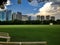 City garden with green grass and buildings