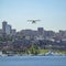 City lake and plane beneath clear blue sky