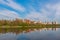 City landscape. Moscow. Residential area Izmailovo and its reflection in the pond in early autumn. View from Izmailovsky Island