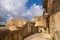 City landscape of old Sicilian Modica city. Sandstone houses, stairway and balconies, courtyards with nobody inside. Bright sunny