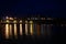 City landscape,of Portree at night with the lights of lamppost reflected on the sea water, Isle of Skye, United Kingdom