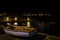 City landscape,of Portree at night with the lights of lamppost reflected on the sea water, Isle of Skye, United Kingdom