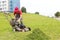 City landscaper unloading grass from lawn cutter bag