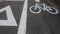 City lane for cyclists and skaters. Bicycle signs on the road. Bicycle road with arrow. Bicycle and modern ecological