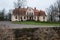 City Liepupe, Latvia. Old yellow manor with garden.Travel photo