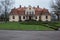 City Liepupe, Latvia. Old yellow manor with garden.Travel photo