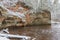 City Ligatne, Latvia. River in winter with sandstone cliffs and caves