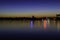 City lights reflecting at night over the water of Herastrau lake