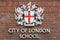 City of London school sign on red bricks wall, London