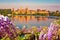 City of Mantova skyline early morning view through flowers from lago Inferiore