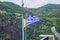 City Meteora, Greek Republic. Mountains and Greek flag. 12. Sep. 2019. Travel photo