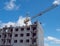 City new building multi-storey building construction crane brick open-air residential complex windows sky