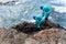 City officials are seen on top of rocks on Rio Vermelho beach cleaning up toxic oil spilled on the Brazilian coast