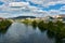 The city of Ourense in Galicia, Spain. View of the Minho river from the Roman Bridge under beautiful cloudy blue sky on a spring