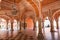 City Palace Jaipur ancient hallway with ancient wall art with columns at Rajasthan India