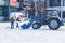 City Park, Balashikha, Russia - February 19, 2021. Mechanized cleaning of fallen snow with the help of harvesting equipment.