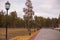 City park with a deserted footpath on a cloudy spring day