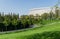 City park Krasnodar. Hedge of evergreens around recreation area with Catalpa bignonioides trees