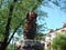 city park wooden sculpture on a stone pedestal