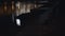 City path at quay with benches at night. Empty benches standing on embankment on background of reflected in water lights