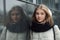 City portrait of young beautiful blonde stylish girl posing in spring fall outdoors in white coat black knitted scarf. Vintage fil