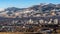 City of Reno Nevada cityscape with hotels, casinos, a blue sky with Mt. Rose and Slide mountain in the background.