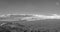 City of Reno Nevada cityscape with hotels and casinos and snow covered mountains in monochrome panorama.