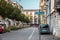 City road with parking cars. Parking with trees and shrubs, city greening