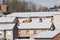 City with the roofs of its buildings covered with snow.