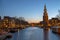 City scenic from Amsterdam with the Montelbaan Tower in the Netherlands at sunset