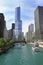 The city skyline along the Chicago River, with passengers tourist boats sailing around