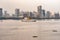 City skyline and Amosud ship and canoes off South Harbor in Manila, Philippines