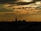 City skyline with church tower silhouette at sunset