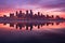 city skyline reflecting onto calm water at twilight
