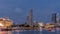 City skyline with skyscrapera and Esplanade Theatres on the Bay in Singapore at dusk, with beautiful reflection in water