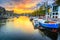 City skyline and water canal with houseboats in Amsterdam, Netherlands