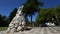 City square with monument to soldier, people having rest in shadow, panorama