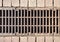 City street brown old rusty metal iron gutter. Gray drain grate for waste and rain water. Street Drainage Sink. Steel